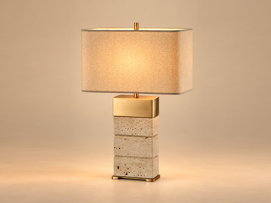 Miles brushed gold table lamp with three stacked beige Classico travertine blocks, rectangular brushed gold detailing and a beige fabric shade.