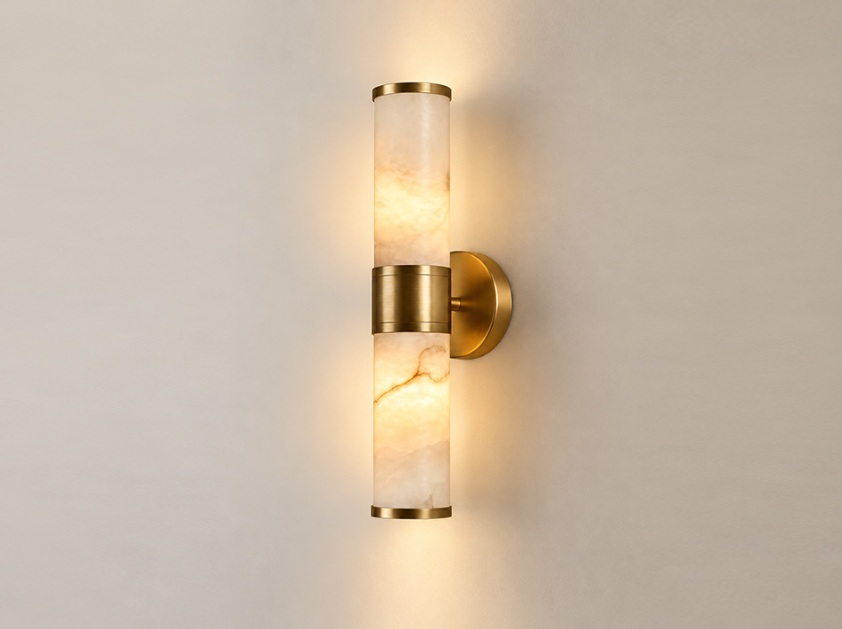 Eve brushed gold double wall sconce with two cylindrical alabaster shades and circular wall plate | Wall Sconces Dubai