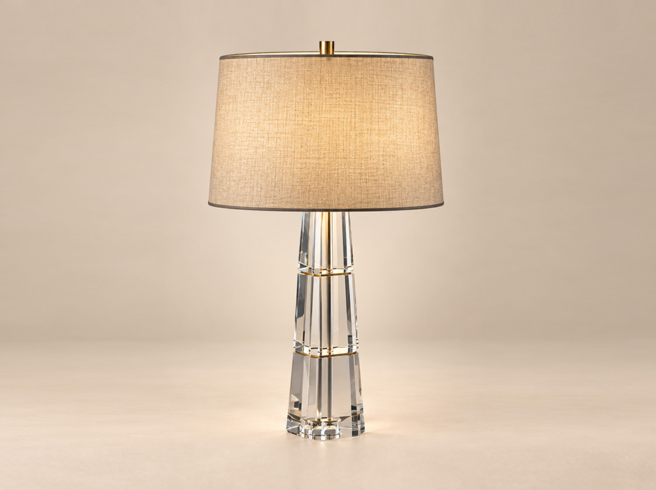 Loki brushed gold table lamp with tall faceted crystal base and light brown linen shade