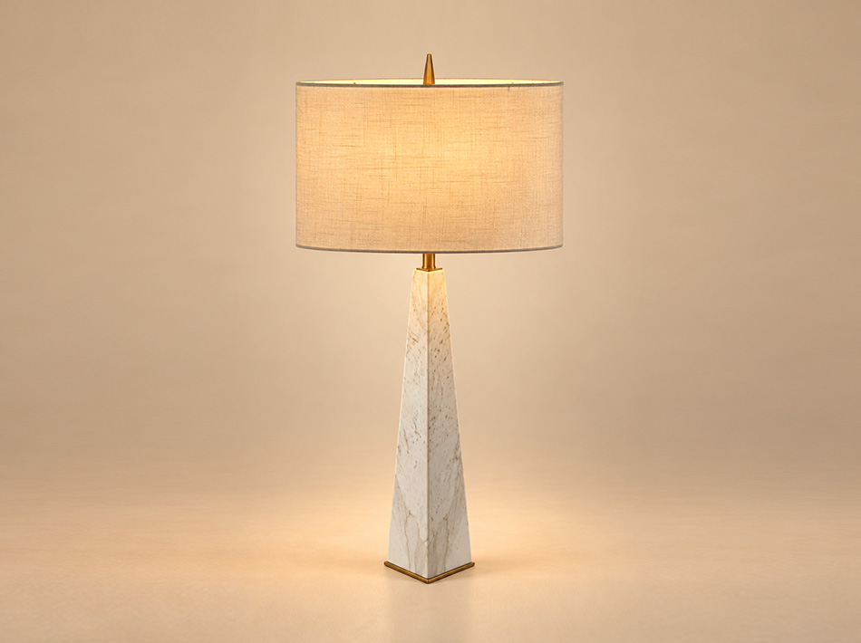 Oxford brushed gold table lamp with tall tapered Jazz White marble base, natural grey veining and circular white linen shade.