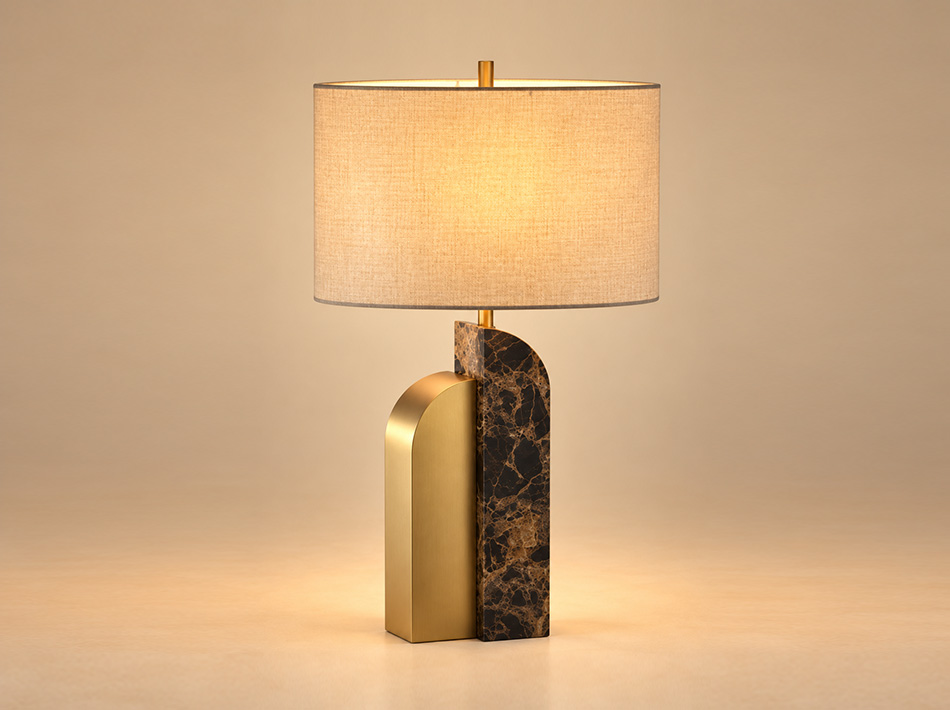 Lazaro brushed gold table lamp featuring an asymmetrical Emperador brown marble and stainless steel base with an oval light brown linen shade.